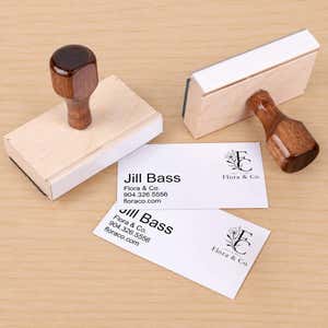 Custom Logo Business Card Stamp resting beside a freshly stamped custom logo impression