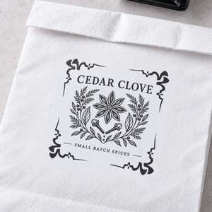 4 Corner Deco Border Logo Stamp in use, with a stamped logo impression on packaging