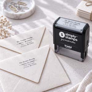 Newman Leafed Out Address Stamp Imprint Example on envelopes next to self-inking stamp body