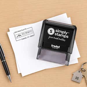 Self-Inking Logo Address Stamp in use, with a stamped logo impression on packaging (second view)