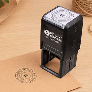 Custom Round Logo Rubber Stamp in use, with a stamped logo impression on packaging