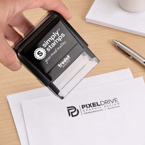 Custom Medium Rectangle Logo Stamp in use, with a stamped logo impression on packaging