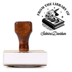Front view of wood handle stamp body with library book stamp impression