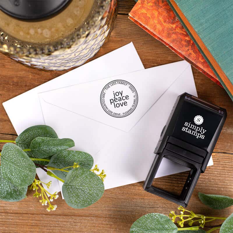 Joy Peace Love Round Address Stamp impression on back of two envelopes top down view