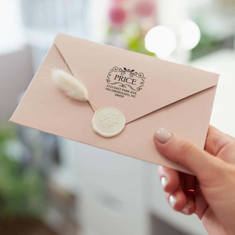 Price Curves Square Address Stamp on back of envelope in hand