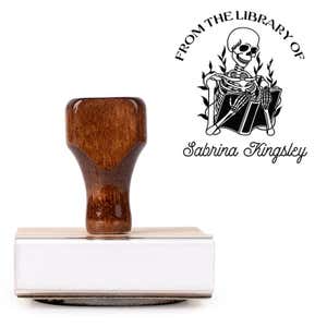 Front view of wood handle stamp body with library book stamp impression