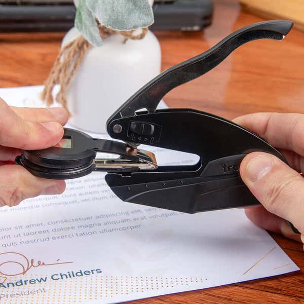 Embossing stamp body with book stamp being inserted