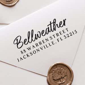 Brush Script Address Stamp impression close up on white envelope