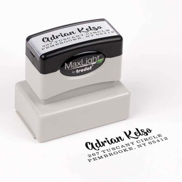 Bold Edgy Script Custom Return Address Stamp impression next to pre inked stamp body