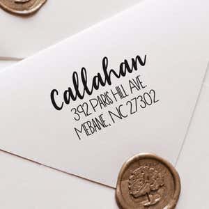 Fully Customizable Script Name Return Address Stamp impression close up on white envelope