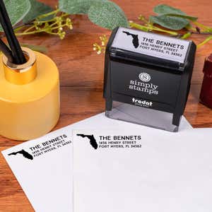 Select Your State Custom Return Address Stamp design impression on two envelopes next to self inking stamp body