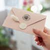 Nautical Coral Reef Round Address Stamp on back of envelope in hand
