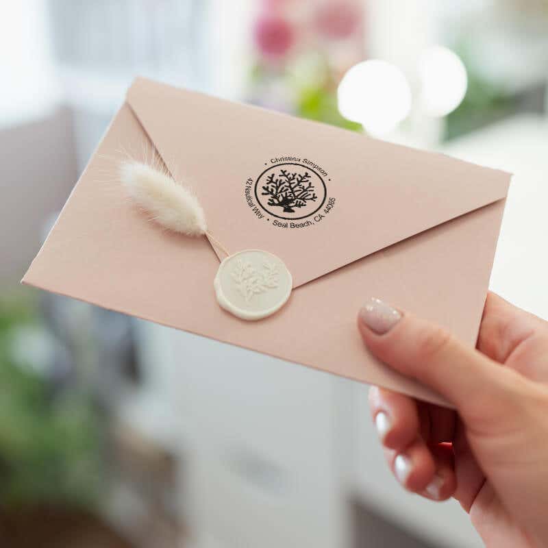 Nautical Coral Reef Round Address Stamp on back of envelope in hand