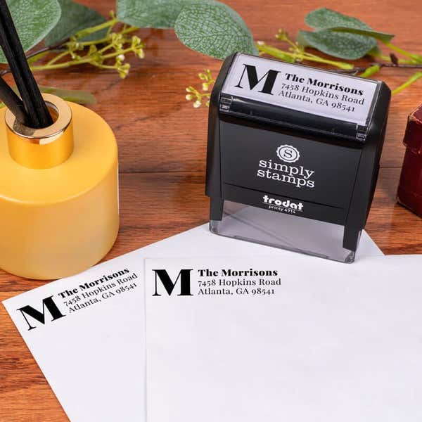 Elevated Monogram Address Stamp Design stamped on two envelopes next to Stamp Body