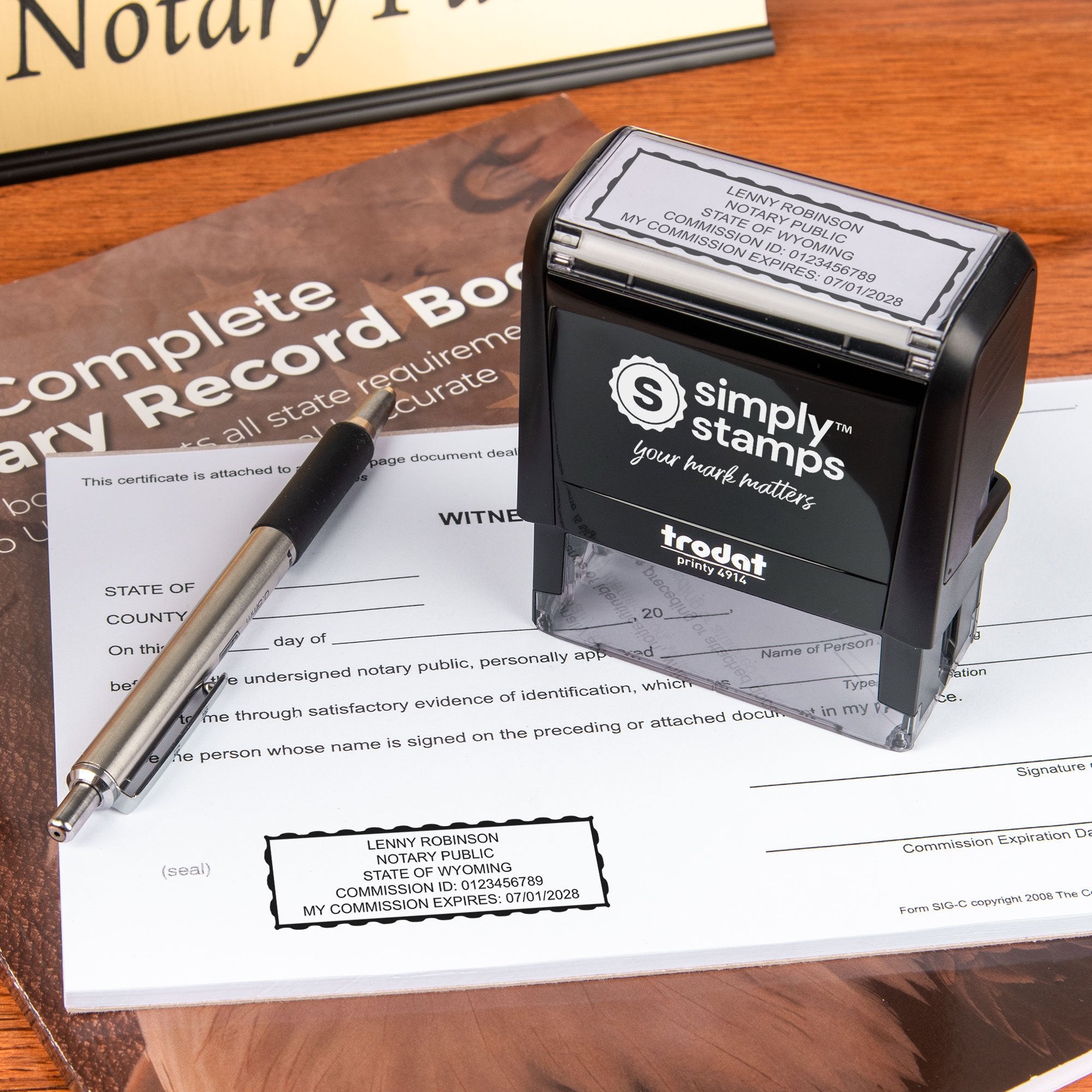The Wyoming Rectangle Notary Seal self-inking stamp being used on a document