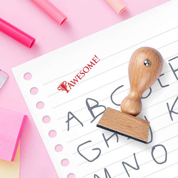 This adorable wood handle teacher stamp measures .75" x 1.875" and is sold with an optional black, blue, red, green or purple ink pad.
