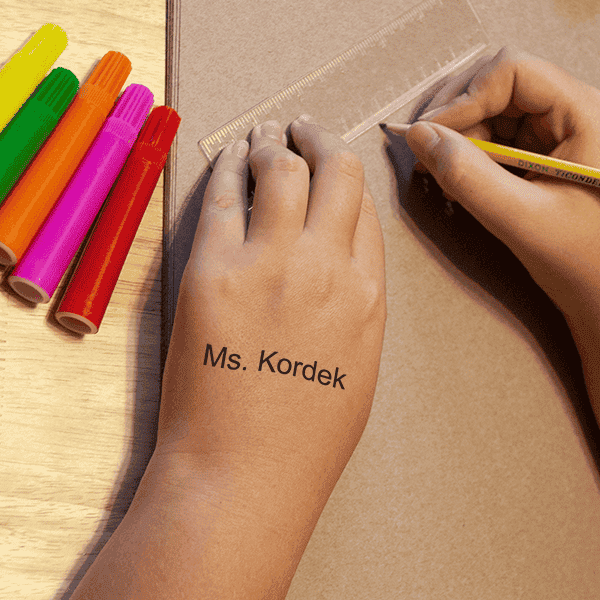 View of the impression of the Teacher Classroom Stamp on a child's hand