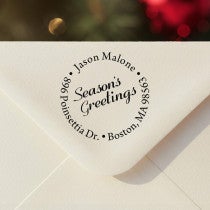 Personalized ‘Season’s Greetings Holiday’ address stamp impression on envelope flap for holiday cards.