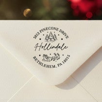 Personalized ‘Santa Sleigh Round’ address stamp impression on envelope flap for holiday cards.