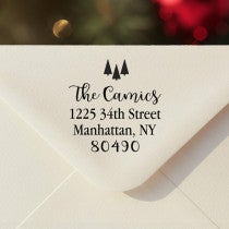 Personalized ‘Tiny Trees Christmas’ address stamp impression on envelope flap for holiday cards.