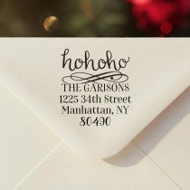 Personalized ‘HoHoHo Christmas’ address stamp impression on envelope flap for holiday cards.