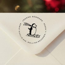 Personalized ‘Sledding Penguin Holiday’ address stamp impression on envelope flap for holiday cards.