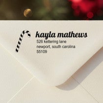 Personalized ‘Mathews Candy Cane’ address stamp impression on envelope flap for holiday cards.