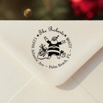 Personalized ‘Roberts Santa Round’ address stamp impression on envelope flap for holiday cards.