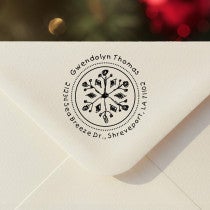 Personalized round ‘Hand Drawn Snowflake’ address stamp impression on envelope flap for holiday cards.