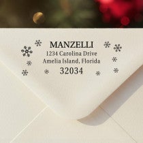 Personalized ‘Manzelli Snowflake’ address stamp impression on envelope flap for holiday cards.
