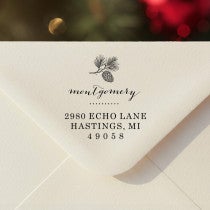 Personalized ‘Montgomery Pine Winter’ address stamp impression on envelope flap for holiday cards.