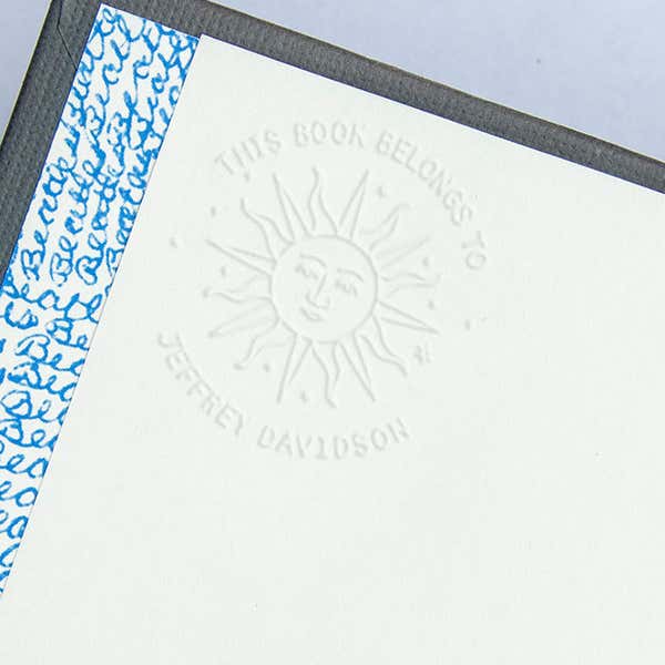 Impression of Modern Sun Embosser Impression on White Paper