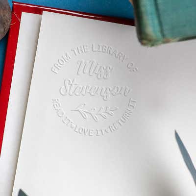 Round Script Name Floral Branch From the Library Of Custom Book Embosser Impression on Book