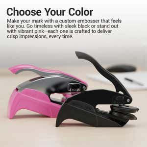 Custom desk embosser shown in black and pink on a desk