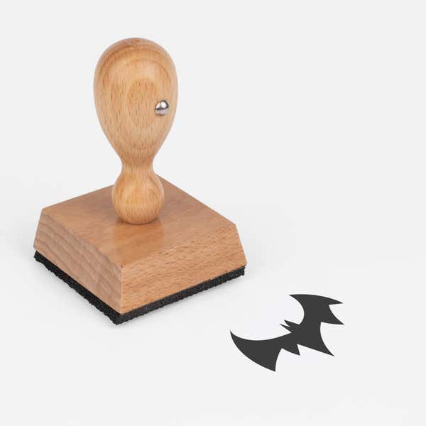 Spooky Bat Craft Stamp at an angle with its wooden handle and block
