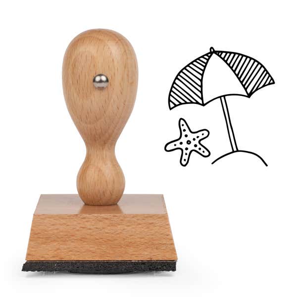 Beach Umbrella Craft Stamp standing upright beside its black stamped beach umbrella image