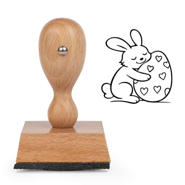 Hoppy Bunny Egg Craft Stamp standing upright beside its black stamped bunny hugging an egg image
