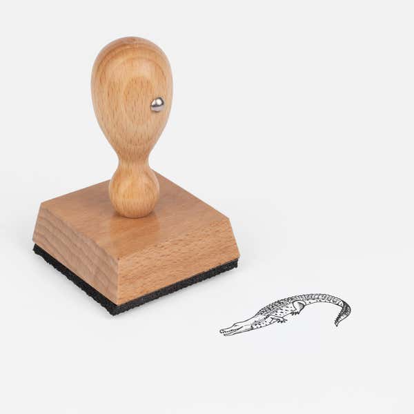 Jungle Crocodile Craft Stamp at an angle with its wooden handle and block
