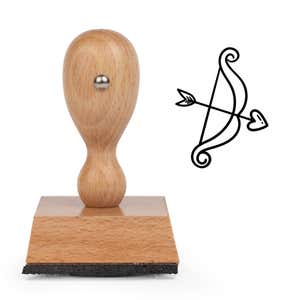 Playful Cupid Bow Craft Stamp standing upright beside its black stamped bow and arrow image