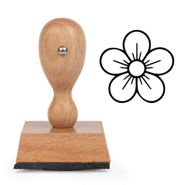 Five-Petal Blossom Craft Stamp standing upright beside its black stamped five-petal blossom image