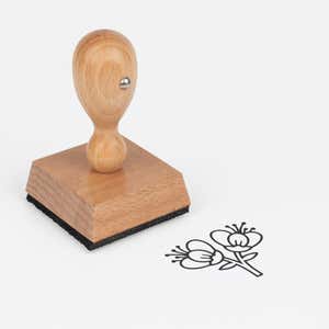 Twin Blossom Branch Craft Stamp at an angle with its wooden handle and block