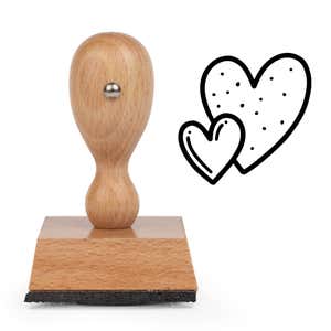 Sweetheart Double Hearts Craft Stamp standing upright beside its black stamped double hearts image