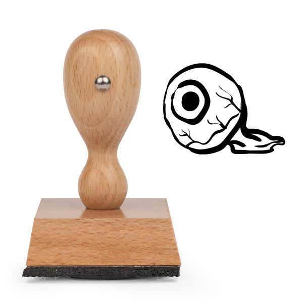 Watchful Eyeball Craft Stamp standing upright beside its black stamped eyeball image