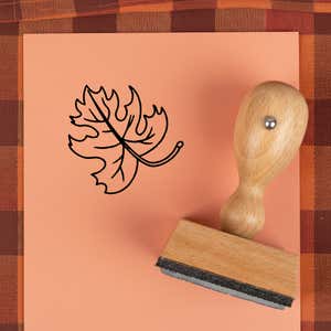 Curly stem lobed leaf stamped in black on peach cardstock on a plaid autumn cloth