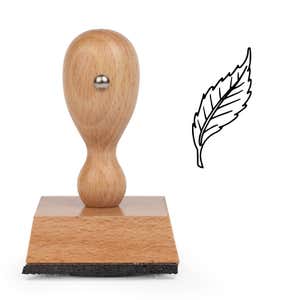 Curved Serrated Leaf Craft Stamp standing upright beside its black stamped curved serrated leaf image