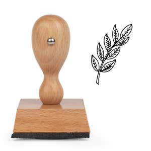 Leafy Branch Sprig Craft Stamp standing upright beside its black stamped leafy branch sprig image