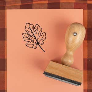 Wavy lobed leaf stamped in black on peach cardstock on a plaid autumn cloth