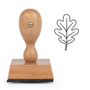 Rounded Oak Leaf Craft Stamp standing upright beside its black stamped rounded oak leaf image