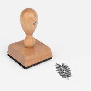Fern Frond Craft Stamp at an angle with its wooden handle and block