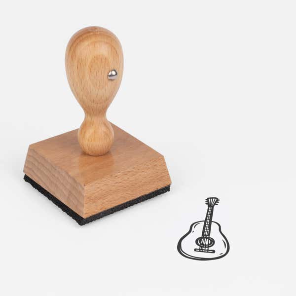 Guitar Craft Stamp at an angle with its wooden handle and block